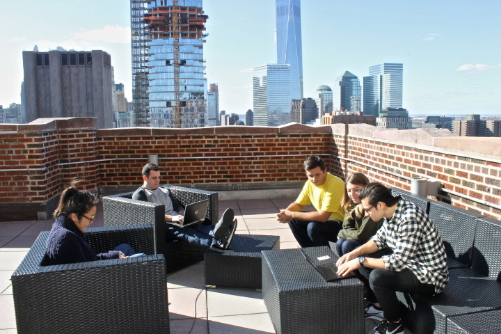 Staffers meeting on the outside patio during the summer