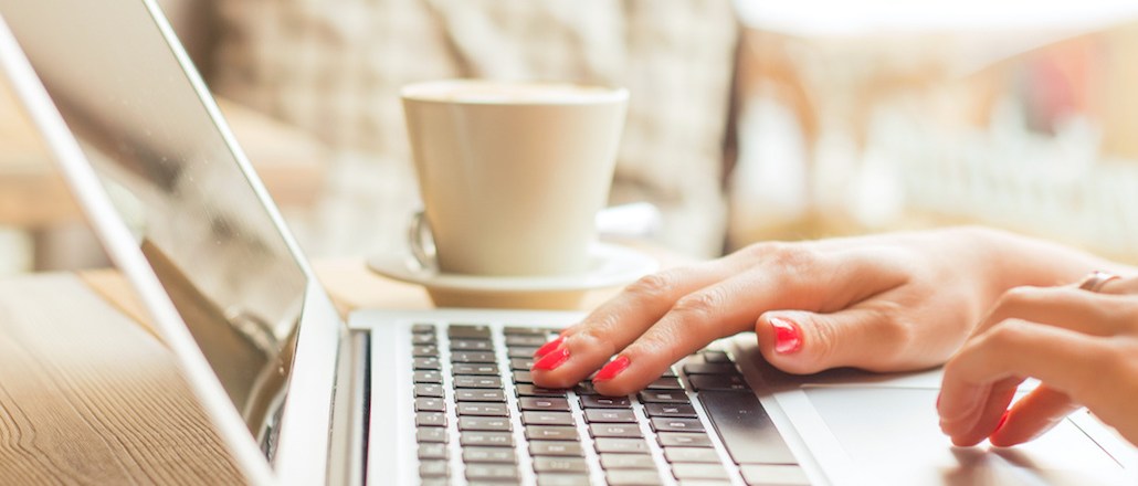 Woman in cafe working on laptop