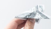 hand with money plane,freedom payment concept.