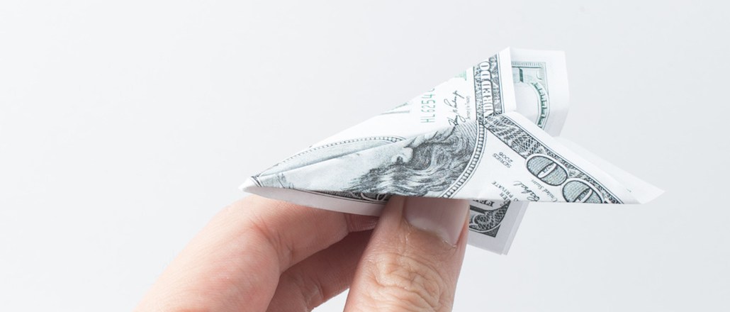 hand with money plane,freedom payment concept.