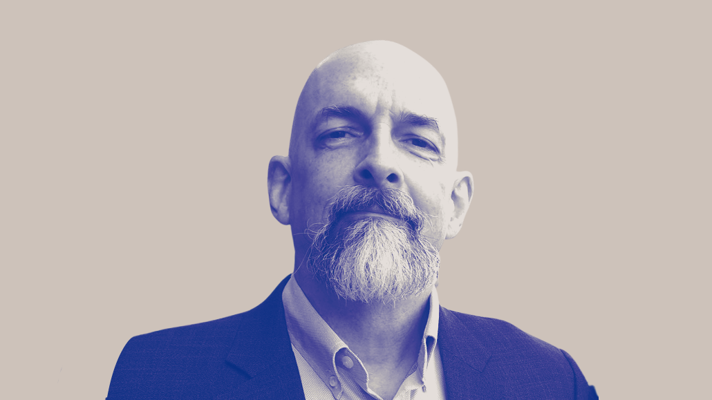Neal Stephenson posing edited to blue and white with tan background